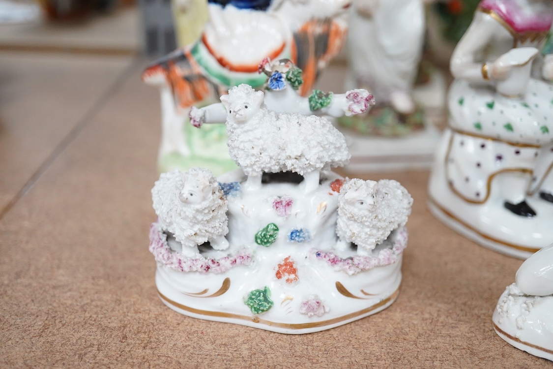 A collection of 19th century and later Staffordshire figures, mostly figural examples, including a pair a rare pair of porcelain seated figures with rabbits and a candle extinguisher, largest 15cm high (15)